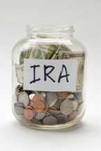 Man counting pennies in jar marked retirement